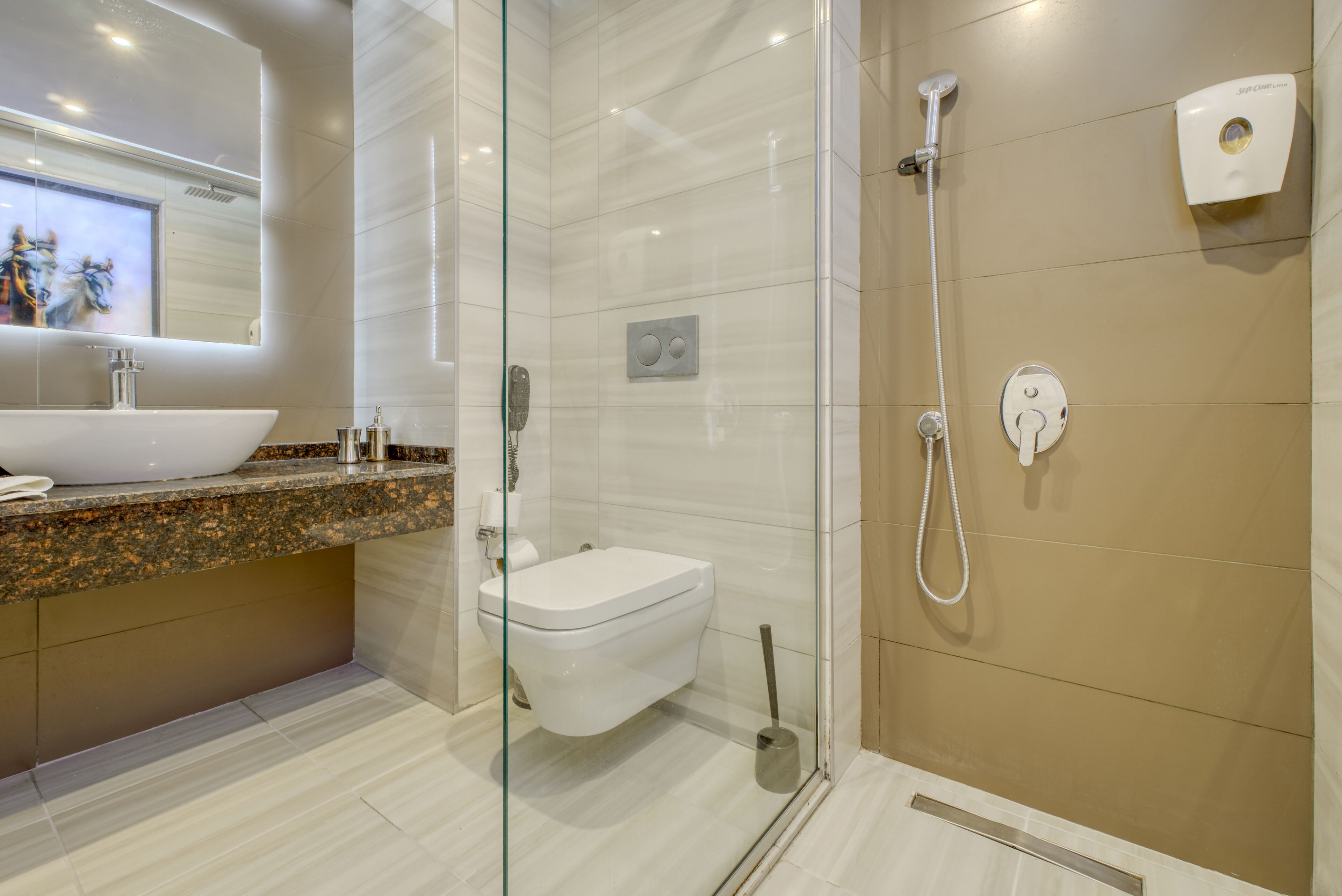 A modern bathroom with a glass-enclosed shower, a white sink, and a marble countertop.