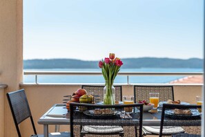 A table set for breakfast with a view of the sea. - Apartment 8 with a stunning view (Trogir)