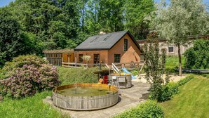 A rustic cabin with a wooden deck, a hot tub, and a slide. - Pet friendly home in Videbæk with WiFi (Videbæk)