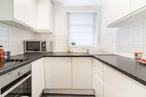 Apartment, 1 Queen Bed | Private kitchen | Fridge, microwave, oven, stovetop