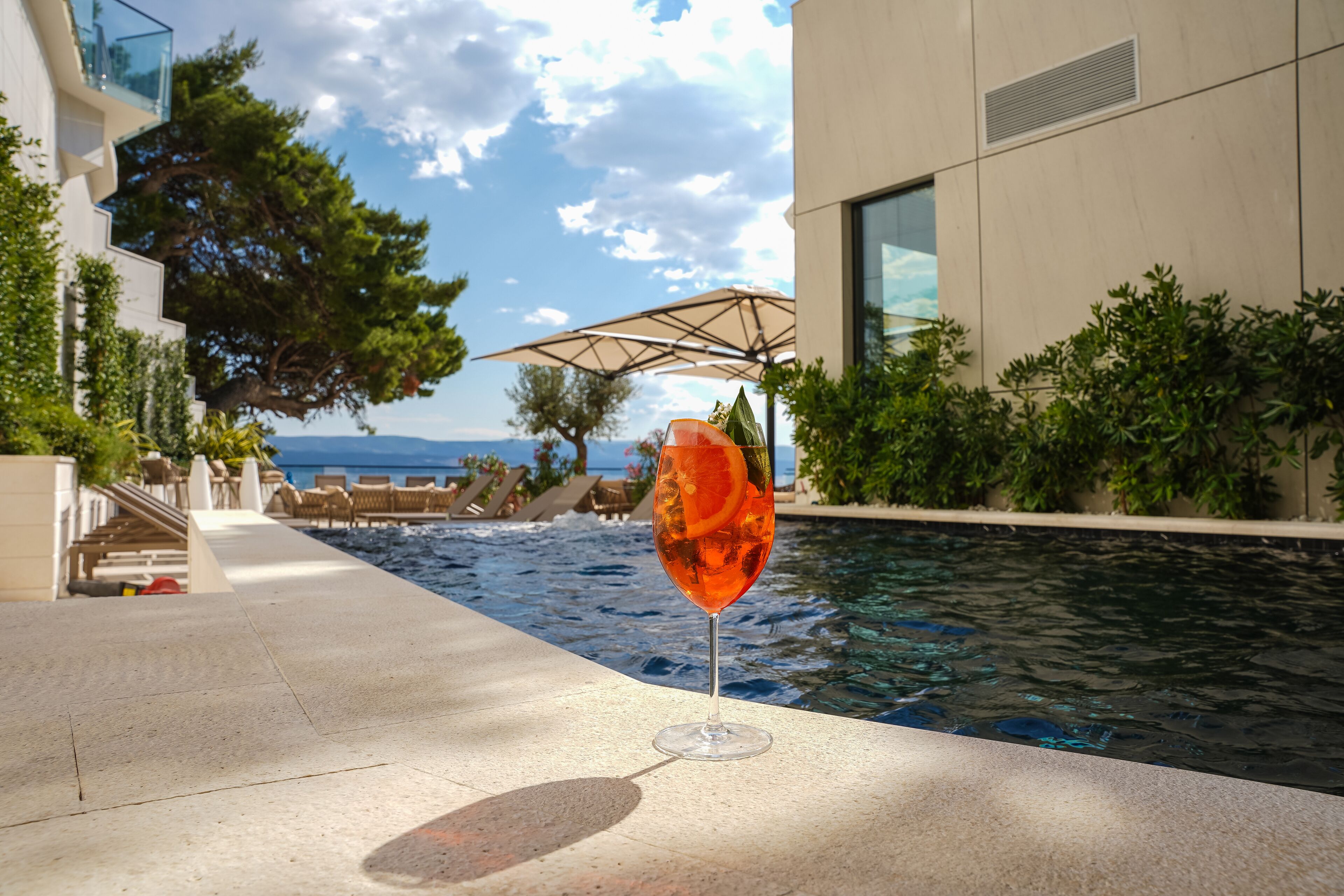 seasonal outdoor pool, pool umbrellas, pool loungers