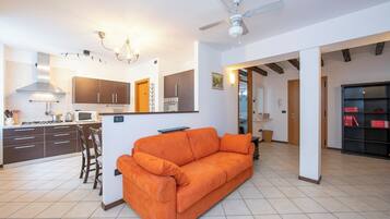 Family Apartment, Multiple Bedrooms (Casa Azzurra 150m From Lake) | Living area | 21-inch flat-screen TV with cable channels