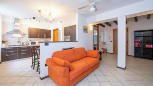 A modern kitchen with dark cabinets, a white countertop, and a built-in microwave. - Casa Azzurra 150m From Lake Garda (Riva del Garda)