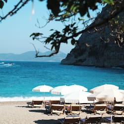 On the beach, white sand, sun-loungers, beach umbrellas