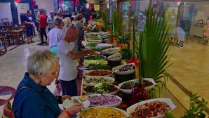 A buffet with various dishes and a large potted plant. - Alexius Beach Hotel (Kemer)