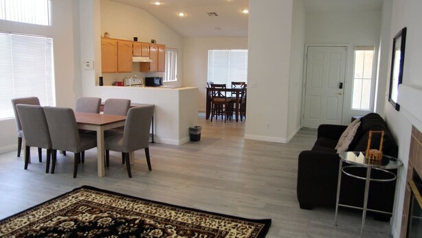 A spacious living room with a dining area, a kitchen, and a separate dining room. - Pet-Friendly Vegas House w/ EV Charger & Parking (Las Vegas)