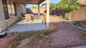 A covered patio with outdoor furniture, a concrete floor, and a gravel area. - Pet-Friendly Vegas House w/ EV Charger & Parking (Las Vegas)