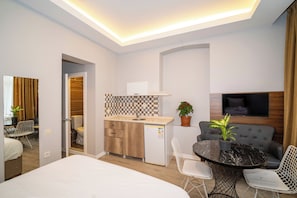 Deluxe Suite | Living area | 40-inch LCD TV with satellite channels, TV, printers