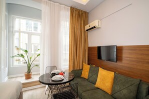 Deluxe Suite | Living area | 40-inch LCD TV with satellite channels, TV, printers