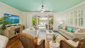 A spacious living room with a pool view, wicker furniture, and a ceiling fan. - **ISLAND INSPIRATION @ OLD TOWN** Home & Pool + Last Key White Glove Service... (Key West)