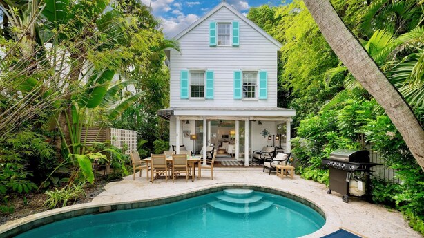 A two-story house with a pool, surrounded by lush greenery. - **ISLAND INSPIRATION @ OLD TOWN** Home & Pool + Last Key White Glove Service... (Key West)