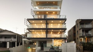 A multi-story residential building with balconies, a driveway, and a truck zone sign. - Kings Surf Unit 6, 5 Ormonde Tce, Kings Beach (Kings Beach)