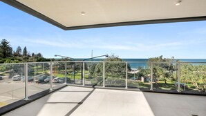 A balcony with a clear view of the ocean and parking area. - Kings Surf Unit 6, 5 Ormonde Tce, Kings Beach (Kings Beach)
