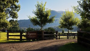Una puerta de madera con un letrero que dice 'Sjoorn Kangaroo Valley 116 Glenmurray Rd'.