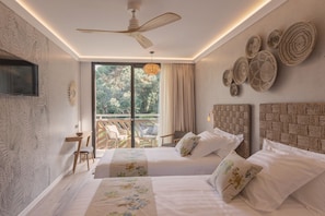 A modern hotel room with two beds, a ceiling fan, a TV, a balcony with outdoor furniture, and decorative woven wall art. - Casa Coco Boutique Hotel Spa Adults Only (Lloret de Mar)
