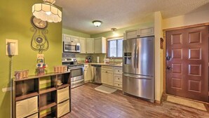 A compact kitchen with a microwave, oven, refrigerator, and wooden cabinets. - Camelback House · Waterparks, Hiking, Wineries - Near Everything!!! (Tannersville)