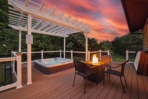 An outdoor deck with a hot tub, a fire feature, and a pergola. - Paradise Pocono | Cresco | Arcade | Pool | Hot Tub (Cresco)