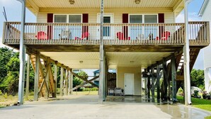 A two-story building with a balcony on the upper floor. - *Beach House!!*Views!!*Steps to Ocean!*Amenities! (Oak Island)