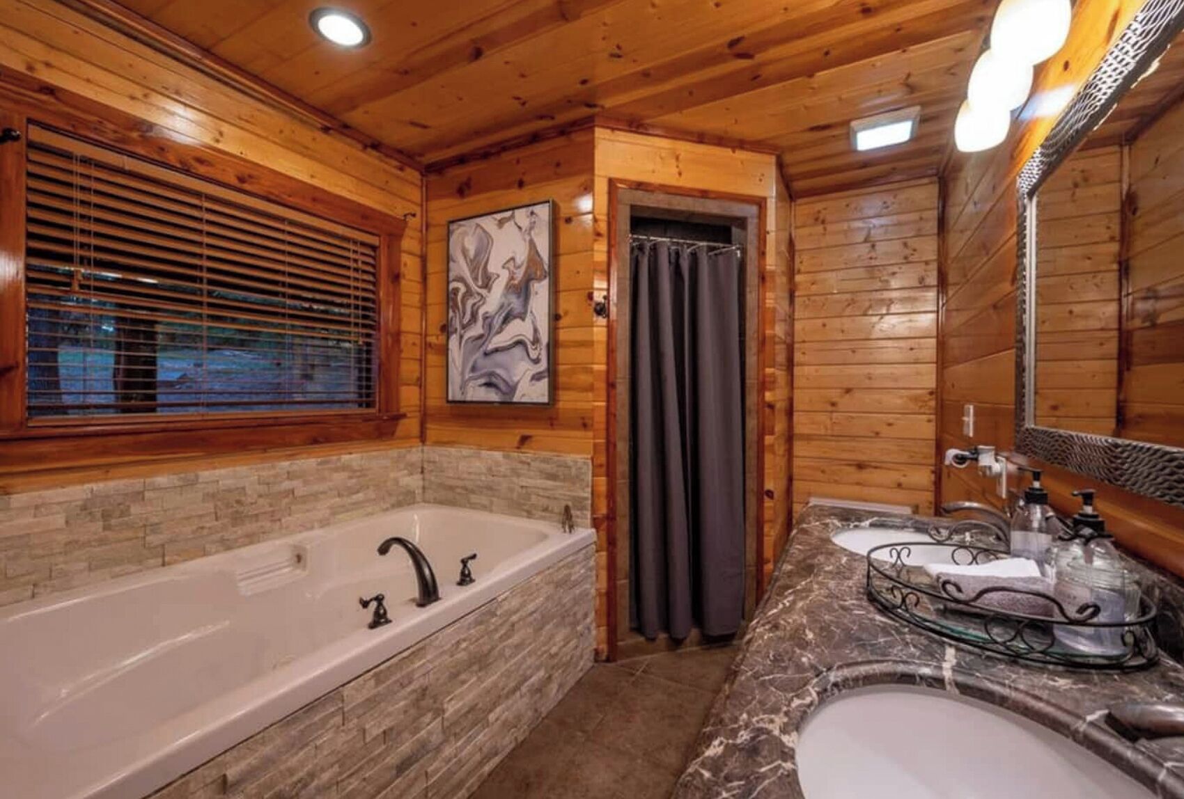 A wooden cabin bathroom with a large bathtub, a sink, and a shower curtain.