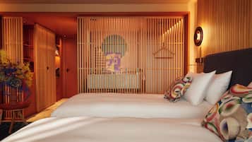 A hotel room with a large bed, a wooden partition, and a hanging light fixture.