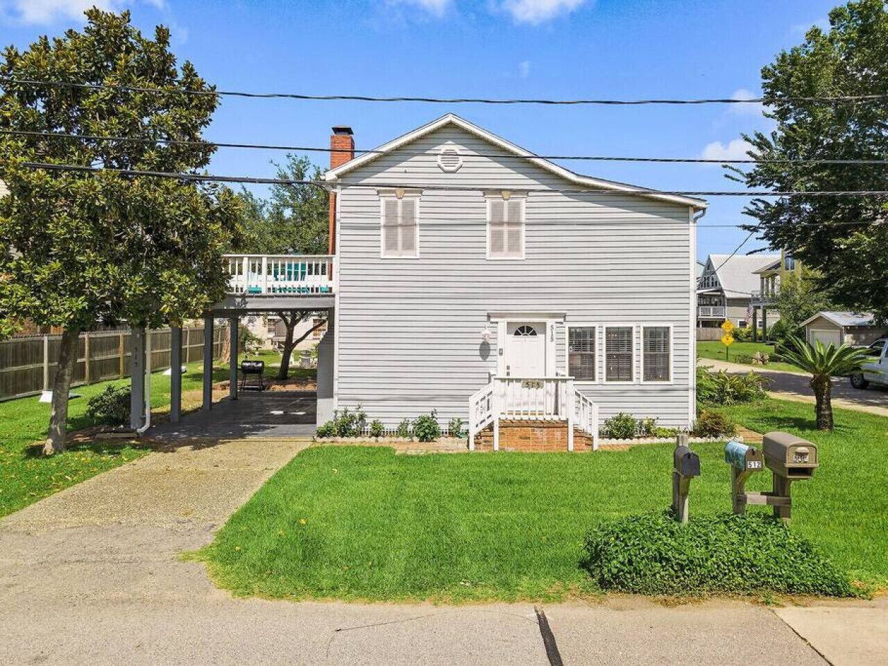 A single-story house with a front porch, a small front yard, and a mailbox.