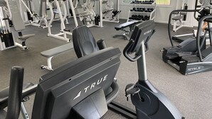 A gym with various exercise equipment including treadmills, weight machines, and dumbbells. - Ocean Keyes 3 BR Condo, XL balcony, pool, 1 block to beach, food,  & famous OD (North Myrtle Beach)