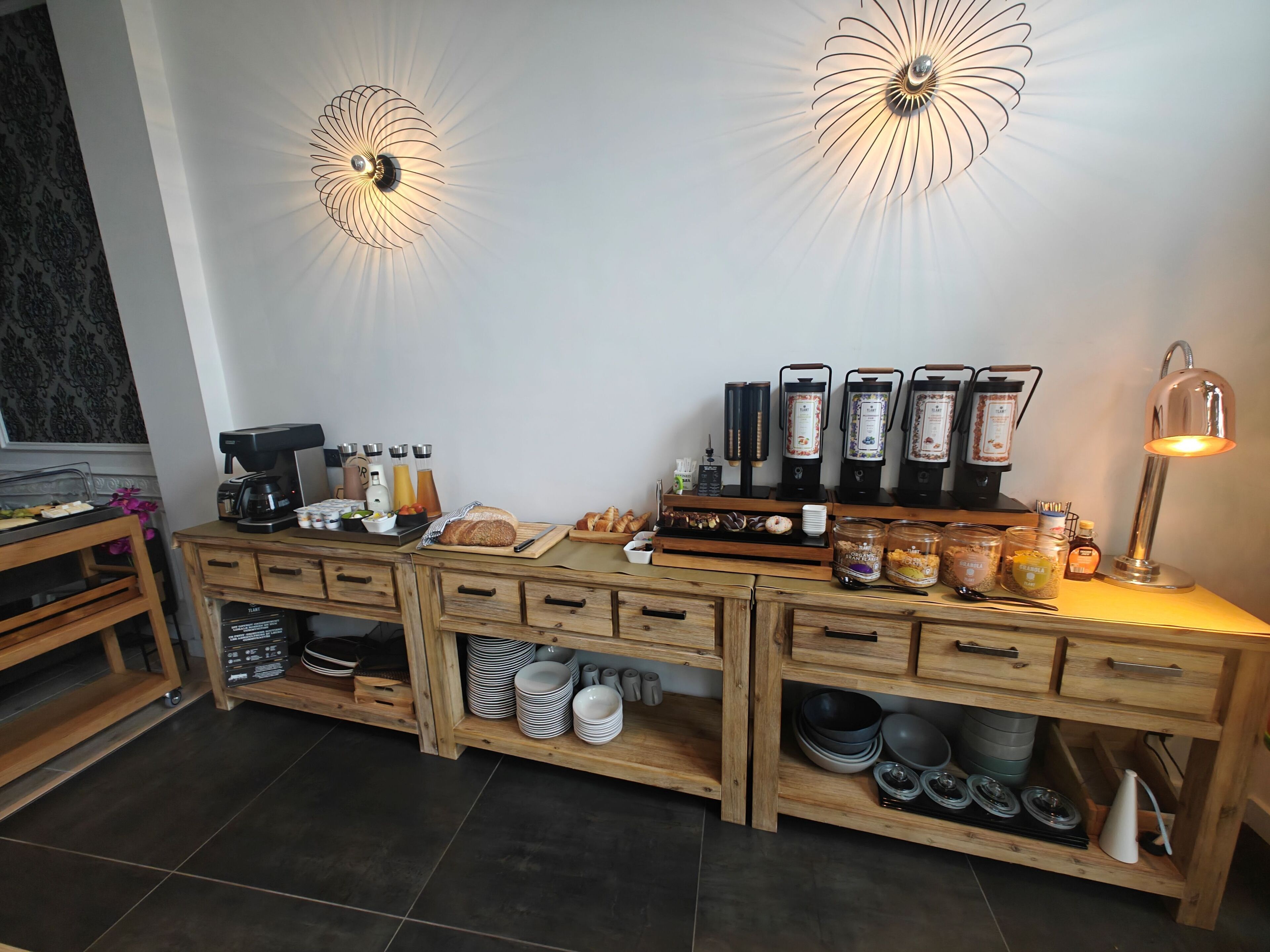 A kitchen area with a coffee station, a bread display, and a coffee machine.