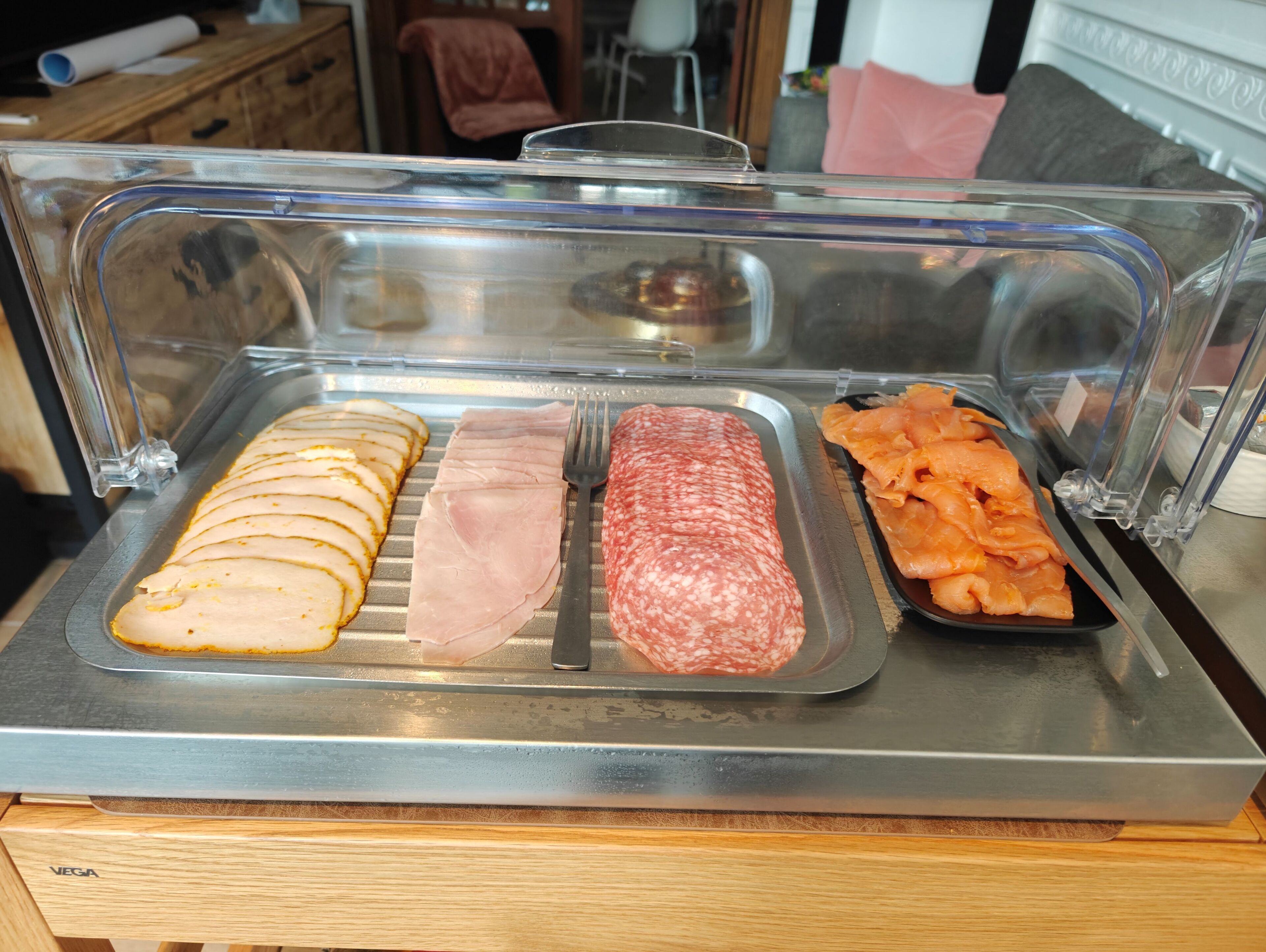 A deli counter with sliced meats and a variety of deli items.