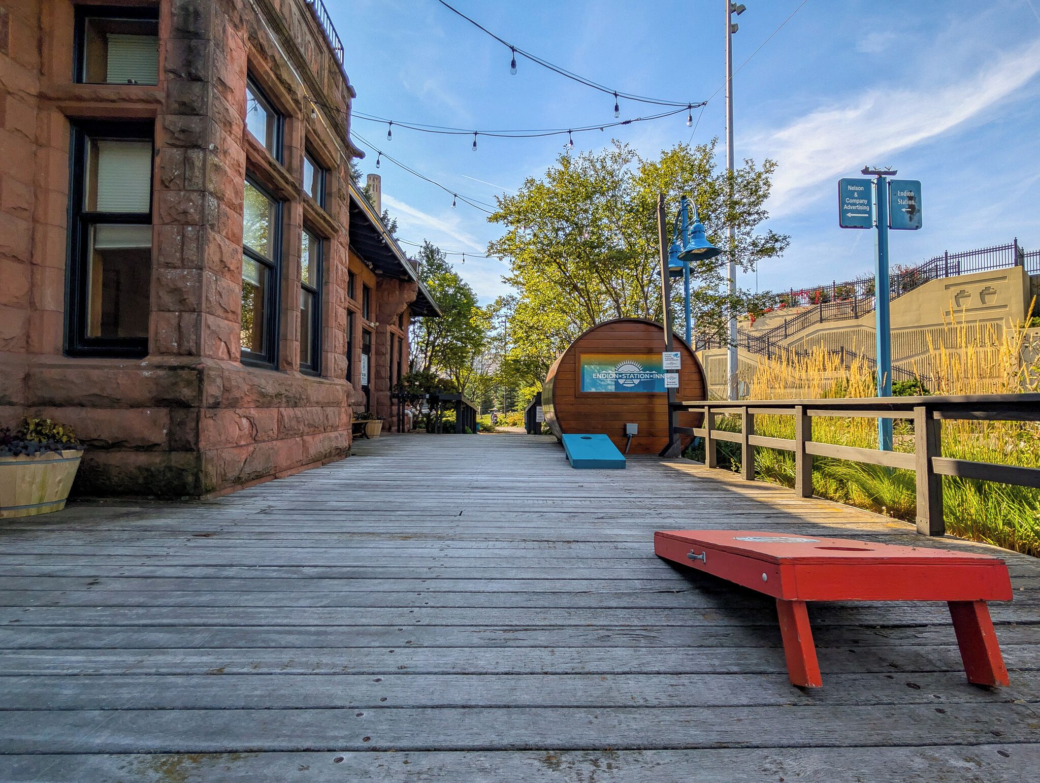 A wooden boardwalk leading to a rustic building with a large barrel-shaped structure labeled "Endion Station Inn".