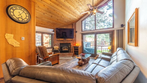 A cozy living room with leather sofas, a fireplace, and a television. - Townhouse at the Woodlands 235 (Mammoth Lakes)