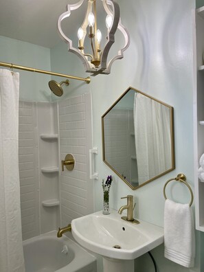 Bathtub, hair dryer, towels, soap