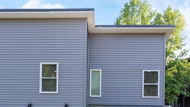 A two-story house with a grey exterior, a garage, and a front door marked with the number 257. - Quiet and cozy new townhome minutes from the mall exit. (Barboursville)