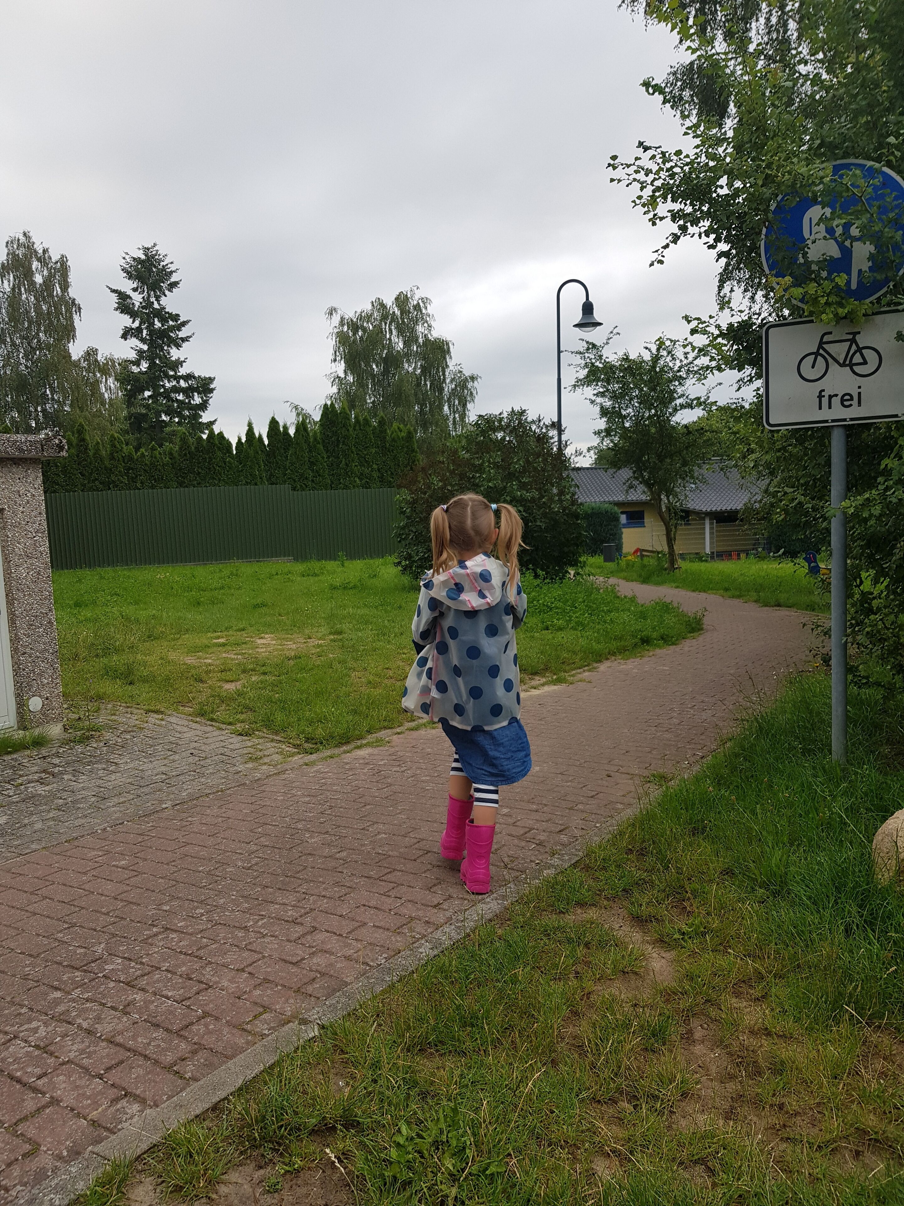 A paved pathway with a sign indicating a bike route.