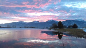 A mountain landscape with a frozen lake reflecting the sky. - Montana Mountain Memories- RV in Orchard by Trout Pond (Florence)