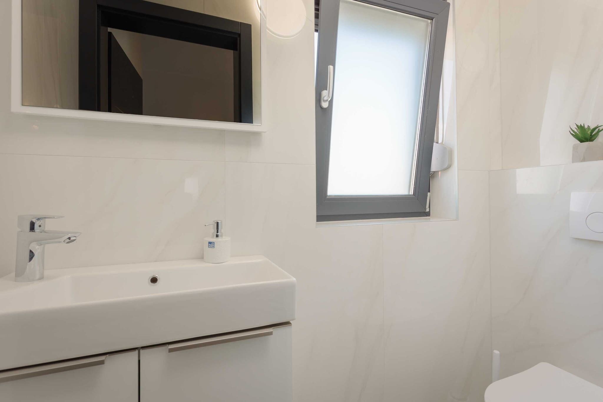 Shower, hair dryer, towels, toilet paper