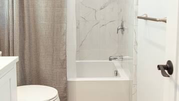 Combined shower/tub, hair dryer, towels, soap