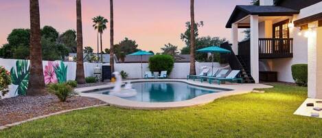 A heated pool, sun loungers