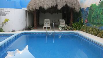 Outdoor pool, open 10:00 AM to 7:00 PM, pool loungers