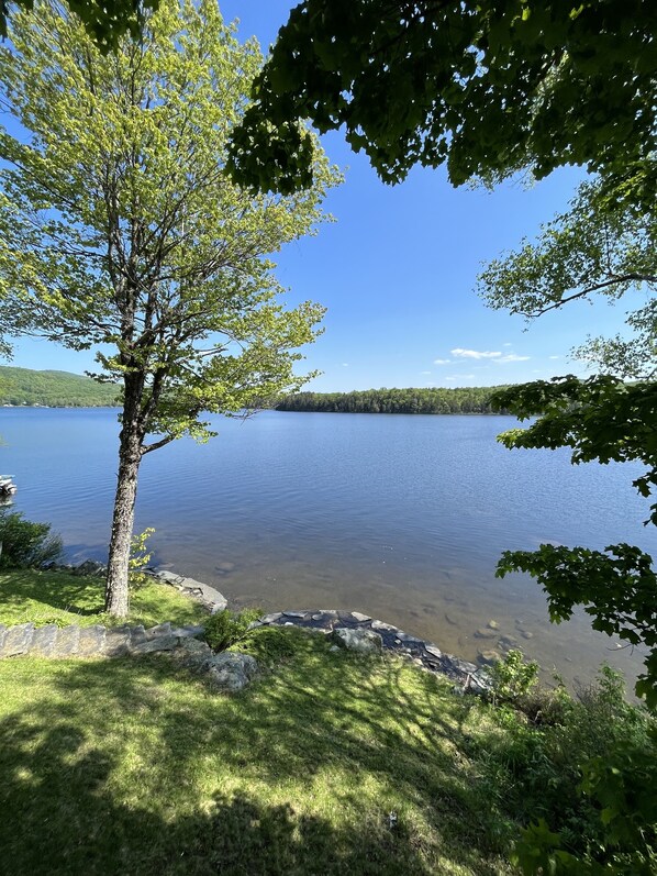 A lake surrounded by trees and a stone wall. - Relaxing waterfront cabin getaway in the Groton State Forest (Peacham)