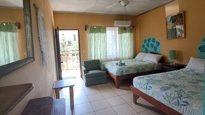 A hotel room with two single beds, a ceiling fan, a small table, and a bench. - Hotel Georgi CR (Veintisiete de Abril)