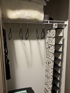 Storage solutions abound in this functional room, featuring a wall-mounted shelf and a padded storage item.