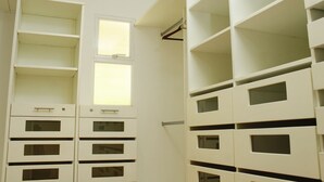 A room with white storage units, a window, and a coat rack. - A house with views in Ccs in a safe area III (Caracas)