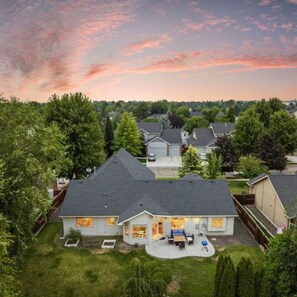 A residential area with multiple houses, each featuring a garage, a covered patio, and a well-maintained lawn. - Lochsa fun in new Meridian (W/D and King Bed) (Meridian)