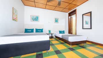 A hotel room with two beds, a ceiling fan, and a checkered floor.