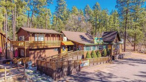 A lodge with a wooden exterior, a balcony, and a sign indicating it is a non-smoking area. - Forest Cabin 5 Old Glory (Payson)