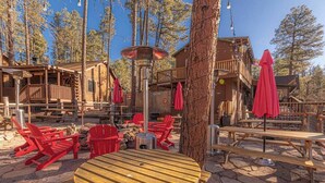 A wooden cabin with outdoor seating and a fire pit. - Forest Cabin 5 Old Glory (Payson)