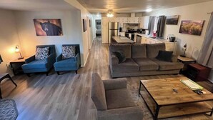 A modern apartment with a living room, kitchen, and dining area. - Forest Cabin 7 Seventh Heaven (Payson)