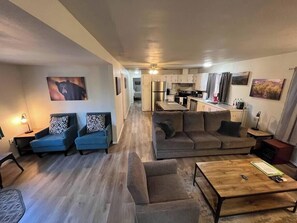 A modern apartment with a living room, kitchen, and dining area. - Forest Cabin 7 Seventh Heaven (Payson)