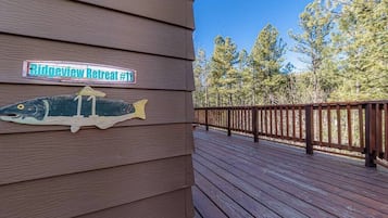 A wooden deck with a sign reading "Ridgeview Retreat #11" and a fish decoration.