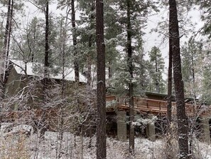 A cabin surrounded by tall pine trees with a wooden deck. - Forest Home Retreat 11 Ridgeview Retreat (Payson)